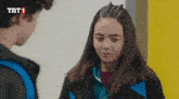 a boy and a girl are standing next to each other with trt1 written on the bottom of the screen