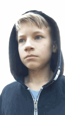 a boy wearing a black hoodie with a zipper