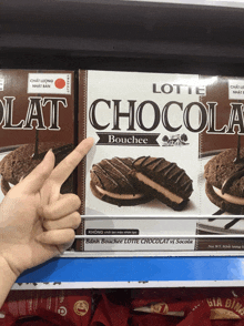 a person points to a box of lotte chocola bouchee cookies