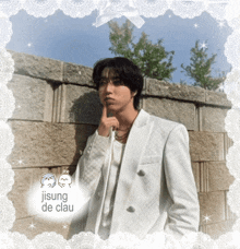a man in a white suit is standing in front of a brick wall with a white lace frame around him