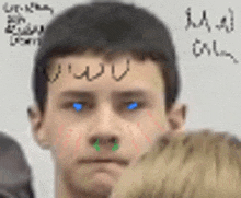 a close up of a man 's face with writing on his forehead .