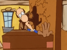 a cartoon character is standing in front of a wall with a hand on it .