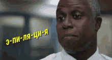 a man wearing a white shirt has a foreign language written on his forehead