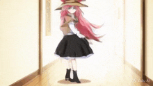 a girl with pink hair is dancing in a hallway with a vidu al watermark