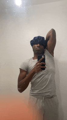 a man wearing a shower cap takes a picture of himself