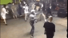 a group of people are dancing in a room with a green screen .