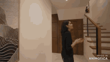 a woman standing in a hallway with the words made in animotica on the bottom right