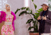 a man and a woman are standing next to a potted plant with a caption that says t4yce tumblr