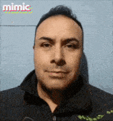 a man in a black jacket with the word mimic on the bottom right