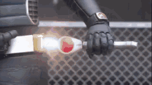 a person in a superhero costume is holding a sword in their hand .