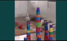 a stack of colorful plastic cups on a table with a rabbit in the background