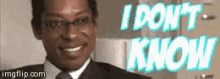a man in a suit and tie is smiling with the words i do n't know behind him .