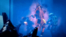 a group of robots are fighting in a dark room and one has the number 1 on it