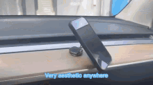 a phone is sitting on a dashboard with the words very aesthetic anywhere