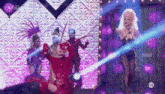 a group of drag queens are dancing on a stage with the number 10 on the bottom right corner .