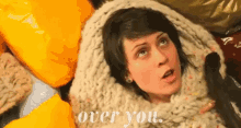 a woman is wrapped in a blanket with the words over you written on the bottom