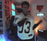 a man is wearing a white jersey with the number 13 on the back