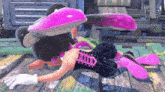 a video game character is laying on the floor with a purple squid on her head