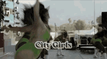 a group of women are dancing and the words city girls are on the bottom