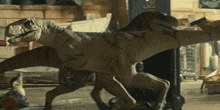 a couple of dinosaurs standing next to each other one of which is holding a gun