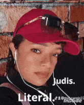 a woman wearing a red hat and sunglasses says judis literal on the bottom