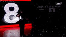 a man is holding a lantern in front of a screen that says royal rumble on it