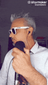 a man singing into a microphone with a starmaker watermark