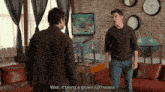two men standing in front of a pinball machine with the words well if being a grown up means