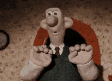 a cartoon character with a surprised look on his face is sitting on a chair