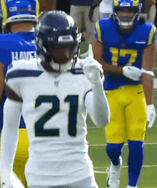 a football player in a white jersey with the number 21 on it