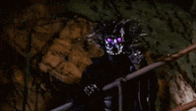 a black monster with purple eyes is standing on a staircase .