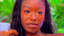 a close up of a woman 's face with a piercing in her nose .