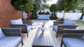 a patio with a table and chairs and a vase of flowers