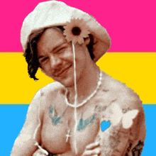 a shirtless man with a flower in his hair and a butterfly on his arm