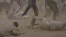 a blurry picture of a crowd of people running in the dirt .
