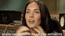 a woman in a recording studio is going on a mission to aid the autobots