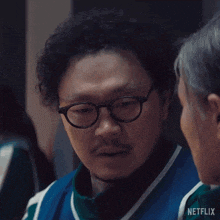 a man with glasses and a beard is talking to a woman in a netflix ad .
