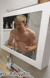 a man without a shirt is looking at himself in a bathroom mirror with the words imboggles on the bottom