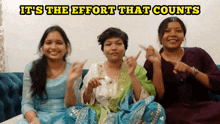 three women sitting on a couch with the words it 's the effort that counts