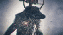a blurry picture of a monster with horns