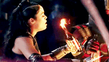a woman is holding a torch in her hand while sitting in a car .