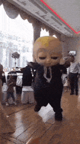 a tiktok video of a baby in a suit and tie dancing