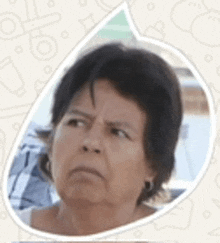 a woman with short hair is making a funny face in a speech bubble .