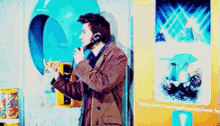 a man is talking on a phone in front of a sign that says toilet