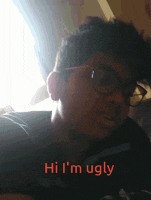 a man with glasses says hi i 'm ugly in red
