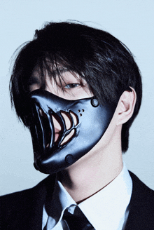 a man in a suit and tie is wearing a black mask