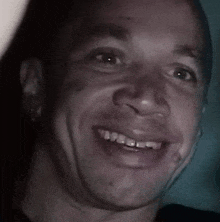 a close up of a man 's face with a smile on it .