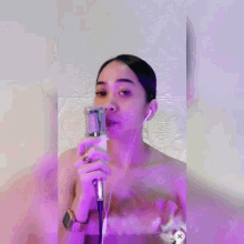 a woman singing into a microphone with the word nyaman written above her