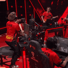 a man wearing headphones and a red shirt that says ' se ' on it
