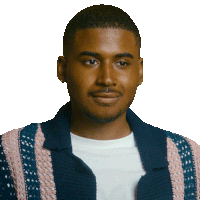 a man wearing a blue and pink striped jacket smiles for the camera